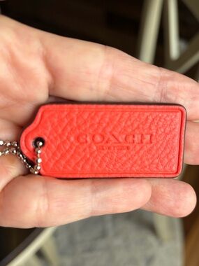 Coach Orange Pebbled Leather Hang Tag Keychain with silver